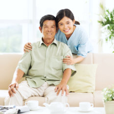 old man and caregiver smiling