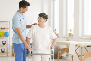 Elderly ward using a walking