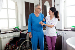 Young beautiful nurse helps to senior