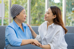 Older Asian woman patient covered the head