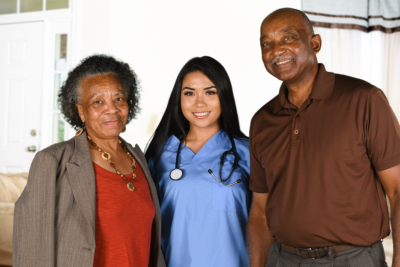 senior couple with woman caregiver