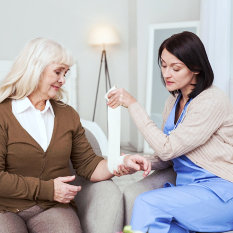 lady assisting the old woman